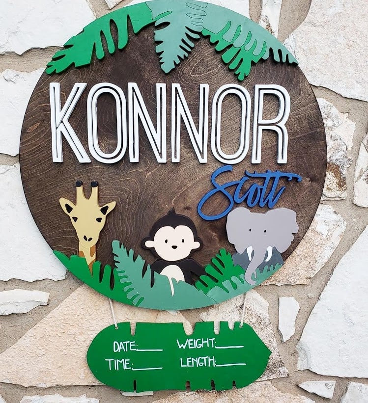  23" round sign with a captivating safari background, adorned with a playful design featuring a monkey, giraffe, and elephant. Customizable with color palettes to perfectly match your kids' rooms, adding a delightful touch to their living space.