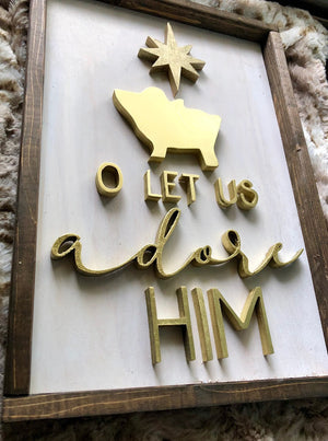 Christmas sign with a gold "Come Let Us Adore Him" text and a charming gold baby cradle design, radiating elegance and celebrating the spirit of the season.